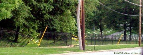 cemetery with broken fence and yellow caution tape