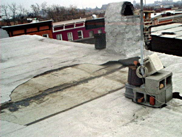 section of roof, looking northeast, showing wind damage