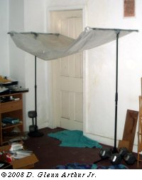 mic stands holding up plastic sheet